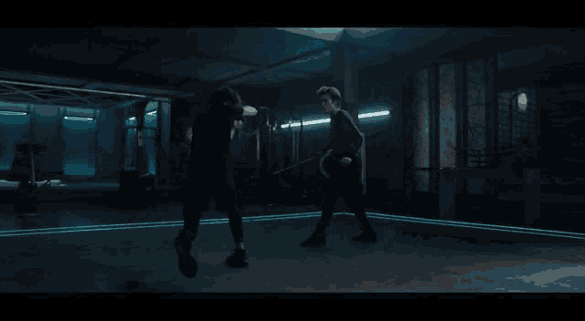 two men are fighting with swords in a dark room with neon lights