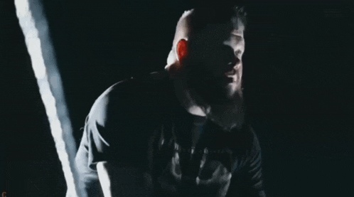 a man with a beard is wearing a black shirt that says " i am a fighter "