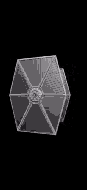 a close up of a silver object on a black background .
