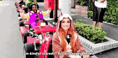 a man and a woman are sitting in a go kart .