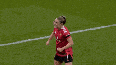 a female soccer player wearing a snapdragon jersey celebrates on the field