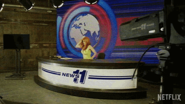 a news desk with a woman behind it and a netflix logo in the corner