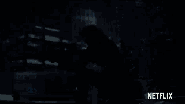 a person holding a sniper rifle in front of a netflix sign