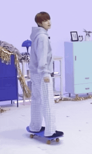 a man in pajamas is riding a skateboard