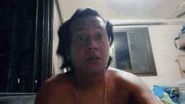 a man without a shirt is looking at the camera