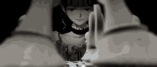 a black and white photo of a girl playing chess