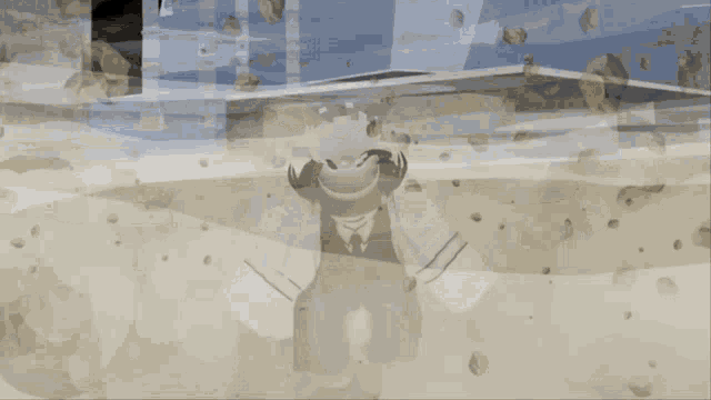 a person in a suit and tie is standing in the sand .