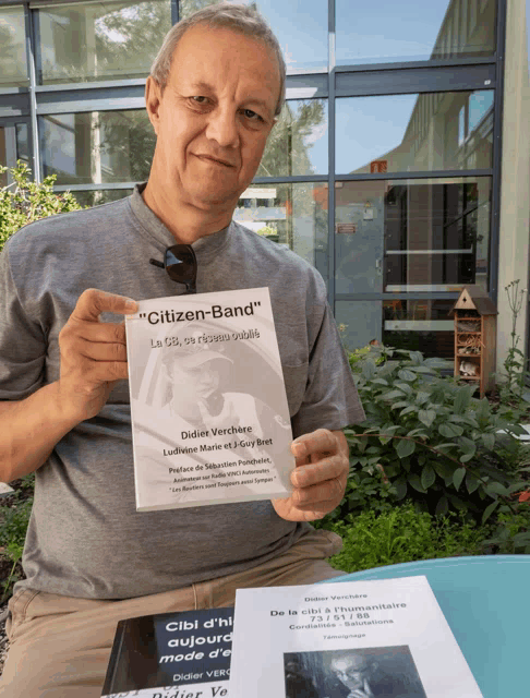 a man holds a book titled " citizen-band "