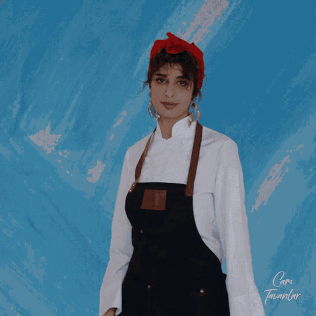 a woman wearing an apron and a white shirt is standing in front of a blue background that says cami
