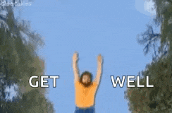 a man with a beard is dancing in the air with the words `` get well '' above him .