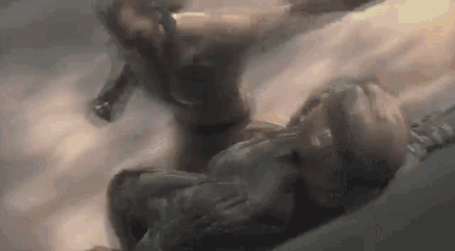 a man is laying on his back in the air while another man is flying in the sky .