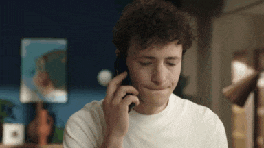 a young man is talking on a cell phone