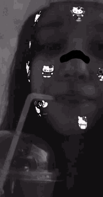 a black and white photo of a girl with a hello kitty face mask