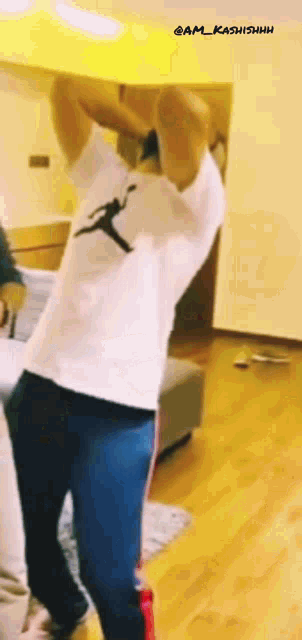 a man wearing a white t-shirt with a jumpman on it