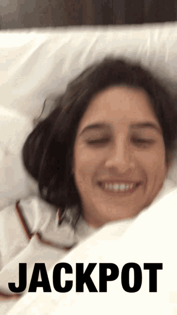 a picture of a woman laying in bed with the word jackpot on it