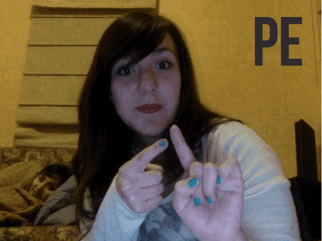 a woman with blue nail polish is giving the middle finger