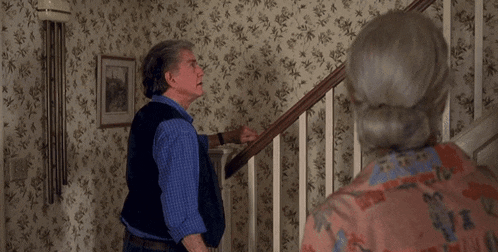 a man and a woman are standing on a set of stairs with the words " what was that all about " above them