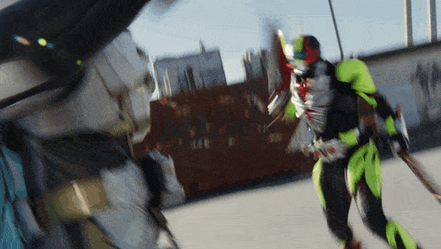 a blurred image of a person in a green and black costume holding a sword