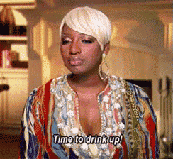 a woman says time to drink up in a colorful shirt