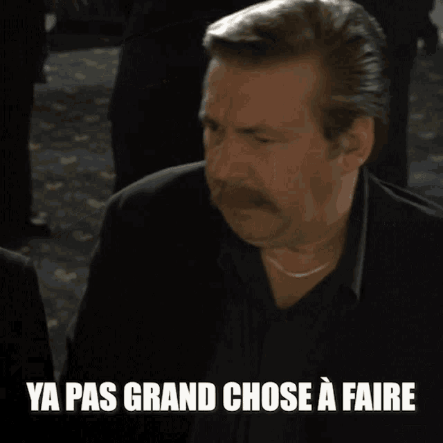 a man with a mustache has the words ya pas grand chose a faire on the bottom