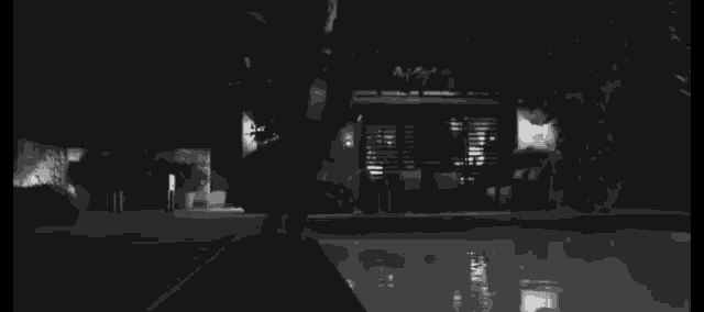 a black and white photo of a person swimming in a pool