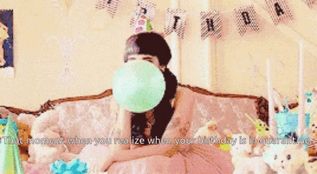 a woman wearing a party hat is sitting on a couch with a birthday banner behind her ..