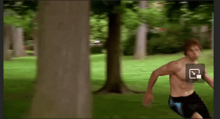 a man without a shirt is running in a park with trees in the background