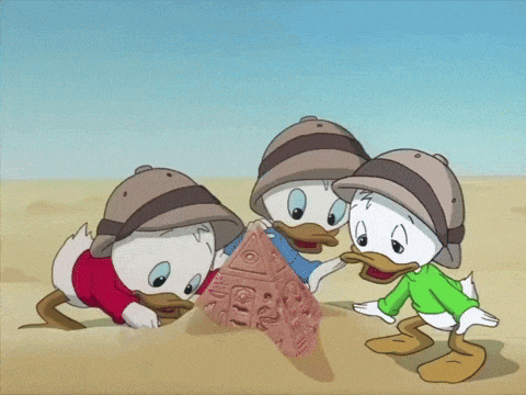 three cartoon ducks are playing in the sand and one of them is wearing a green shirt