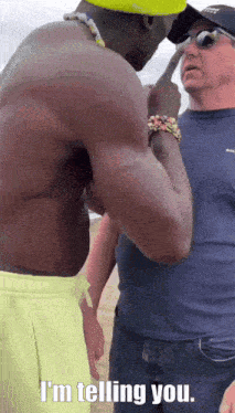 a shirtless man talking to another man with the words i 'm telling you written below him