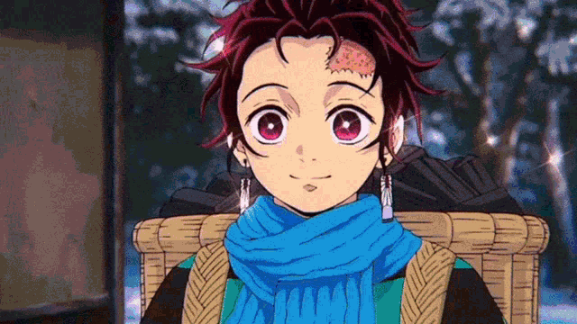 a close up of a person wearing a blue scarf and earrings .
