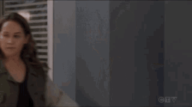 a couple of women standing next to each other in a room .
