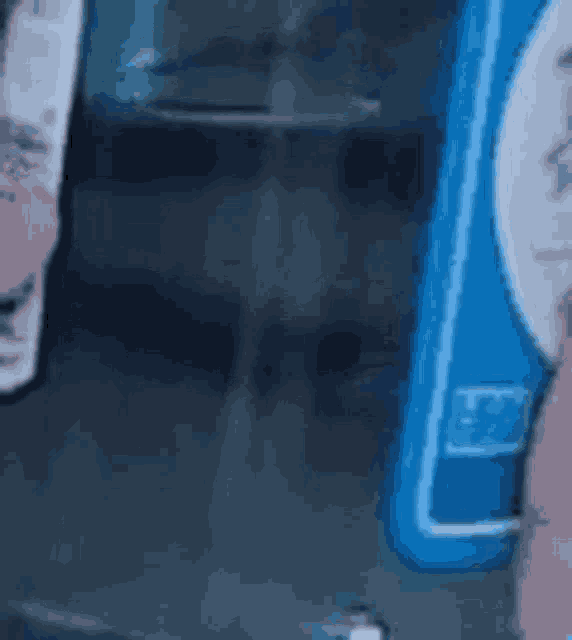 a person is holding a bottle of shampoo and a bottle of conditioner .