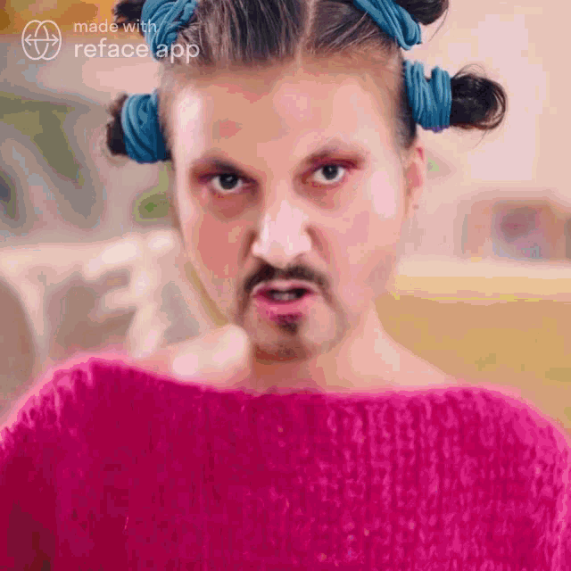 a man in a pink sweater has a beard and pigtails on his head
