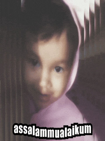 a baby wearing a pink hoodie with the words assalamualaikum written on it