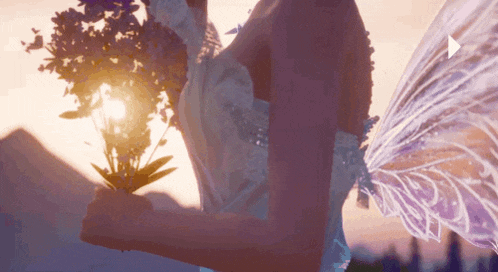 a woman in a fairy costume holds a bouquet of flowers