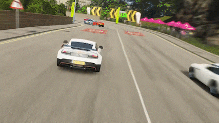 a white car is driving down a road with a yellow sign that says kk on it