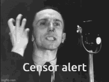 a man in a suit and tie is giving a speech in front of a microphone with the words `` censor alert '' .