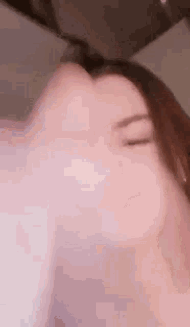 a close up of a woman with her eyes closed .