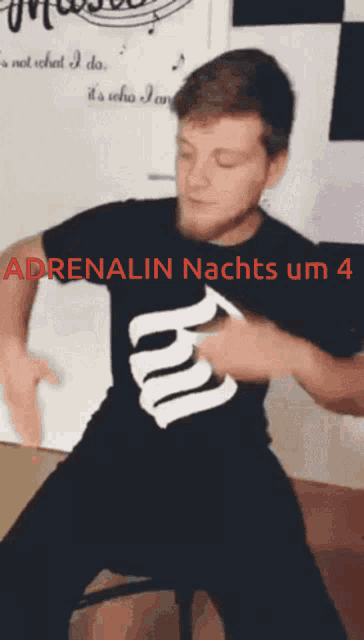 a man in a black shirt that says adrenalin nachts um 4 on it