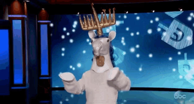 a person in a unicorn costume with a menorah on their head