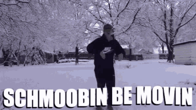 a man in a nike hoodie is running in the snow with the words schmoobin be movin above him