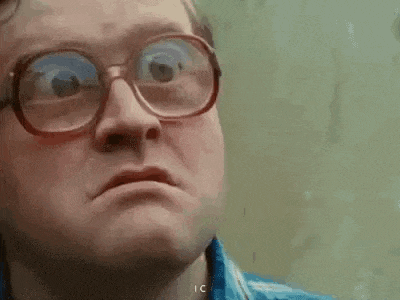 a man wearing glasses is making a funny face and making a funny face .