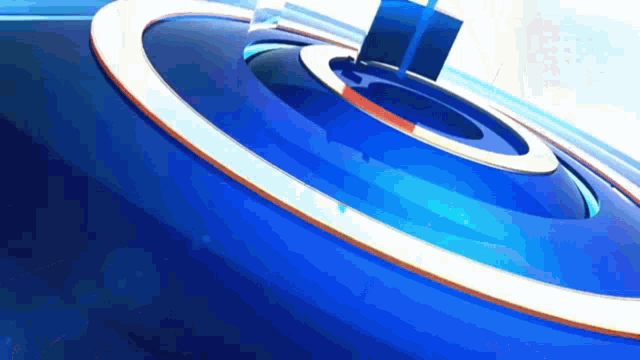 a blue circle with a white border is spinning in the air