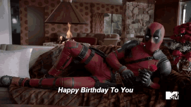 deadpool is laying on a couch holding a rose with the words happy birthday to you above him