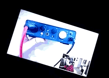 a picture of a person holding a blue device with a pink cable
