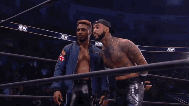 two men in a wrestling ring with aew banners on the ropes