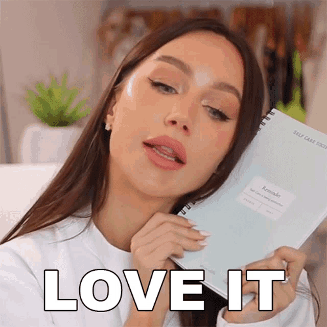 a woman is holding a notebook that says reminder on it