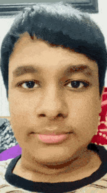 a close up of a young man 's face with a pink lip color