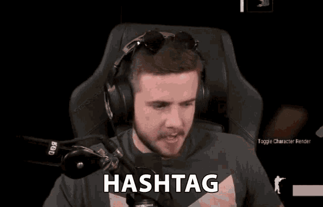 a man wearing headphones and sunglasses is sitting in front of a microphone and says hashtag .