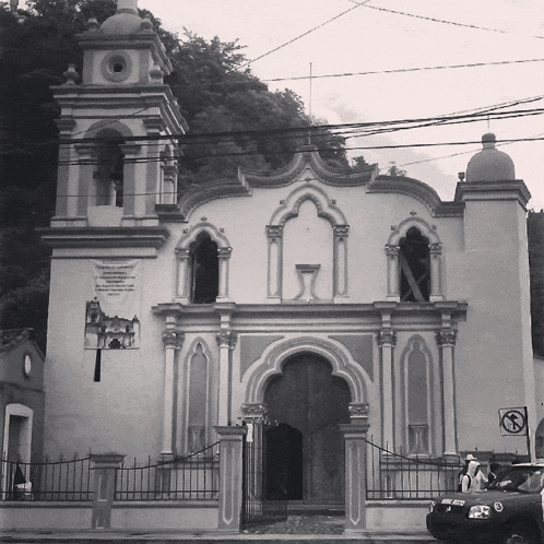 a black and white photo of a church with a sign on the side that says ' a ' on it
